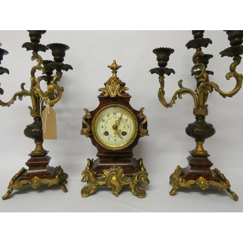 226 - A late 19th century French rouge marble and gilt metal mounted three piece clock garniture, candlest... 