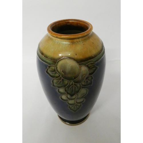 234 - A Royal Doulton stoneware vase decorated with autumnal fruit on a blue background, 20cms tall