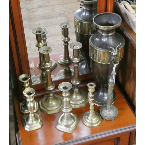 125 - Two pairs of brass candlesticks, three others and a brass oxidised vase