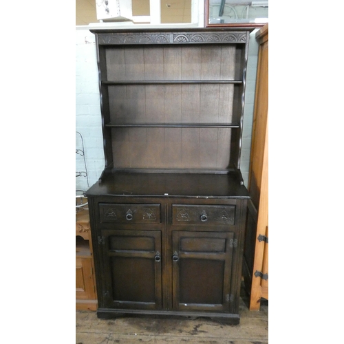 132 - A reproduction oak dresser with shelf back, drawers and cupboards under, 37