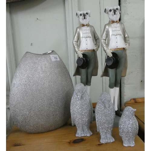 152 - A pair of dressed bulldog ornaments, a contemporary silver coloured vase and three glittery penguins