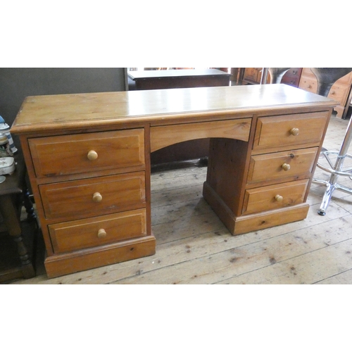 156 - A modern pine kneehole pedestal desk fitted seven drawers, 5' wide