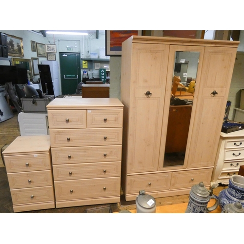 169 - A modern limed oak finished three piece bedroom suite comprising: 4' wardrobe with centre mirror and... 