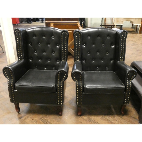 286 - A pair of buttoned wing back easy chairs in studded black faux leather