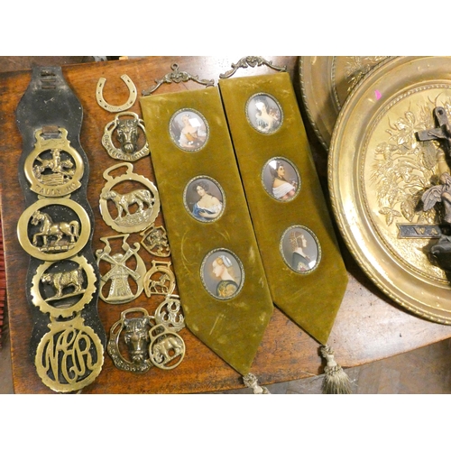 303 - Two circular brass plaques, horse brasses, a font and two miniature style wall hanging plaques