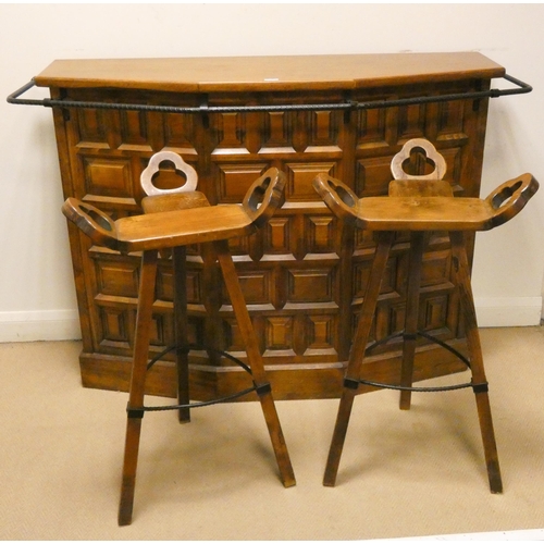 77 - Spanish carved oak bar and a pair of ornate wooden bar stools