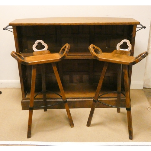 77 - Spanish carved oak bar and a pair of ornate wooden bar stools