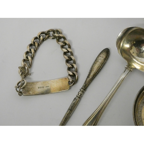 407 - A gents silver ID bracelet, silver handled button hook, German silver sauce ladle and a pin tray