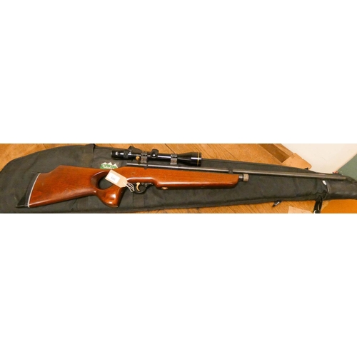 686 - A Cosmk 5.5 calibre air rifle with a telescopic sight in a black soft carrying case - gas powered...