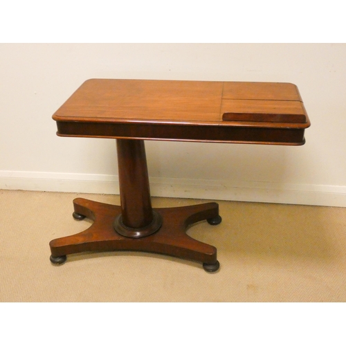 329 - A Victorian mahogany over bed table with reading slope standing on a pillar and platform base