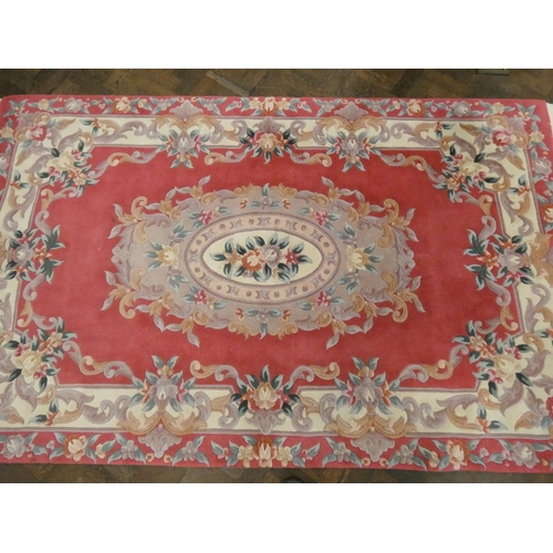 336 - A pink and floral embossed Chinese rug, approximately 5'6 x 8'