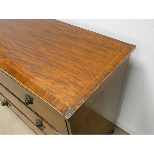 347 - A Georgian mahogany cross banded chest of three long drawers on splayed bracket feet with lion mask ... 