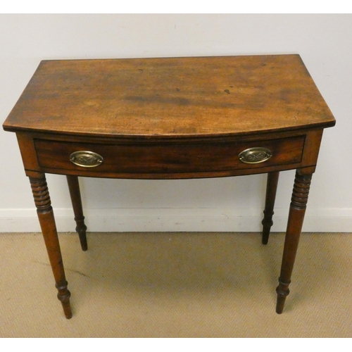 365 - A late Georgian mahogany bow front hall table fitted one long drawer on turned legs