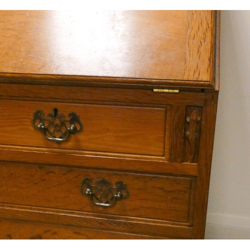 379 - A Derek ' Lizardman'  Slater light oak bureau with three long and two short drawers under, with bras... 