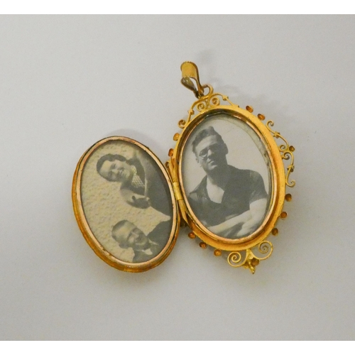 419 - A 19th century high carat gold oval locket, with granulated decoration and split pearl inset. Glazed... 