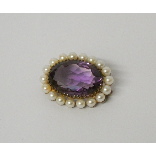 441 - A 19th century oval amethyst and pearl brooch, unmarked yellow metal mount. Diameter 3cms.