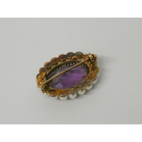 441 - A 19th century oval amethyst and pearl brooch, unmarked yellow metal mount. Diameter 3cms.