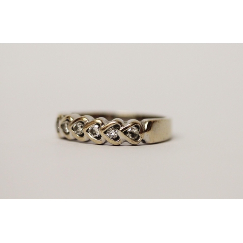 474 - An 18ct gold diamond set half hoop eternity ring, the brilliant cut diamonds in heart shaped setting... 