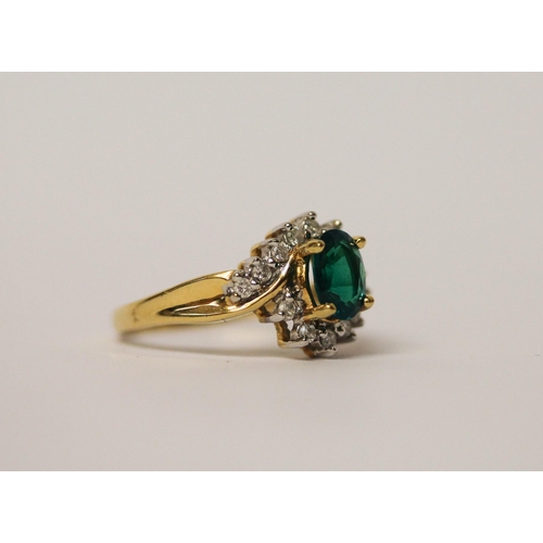 488 - An 18ct gold emerald and diamond oval cluster ring, on hallmarked yellow gold band, ring size M, gro... 