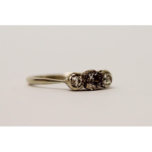 523 - A three stone diamond ring, on 18ct white gold band, ring size I/J, weight 2.4g