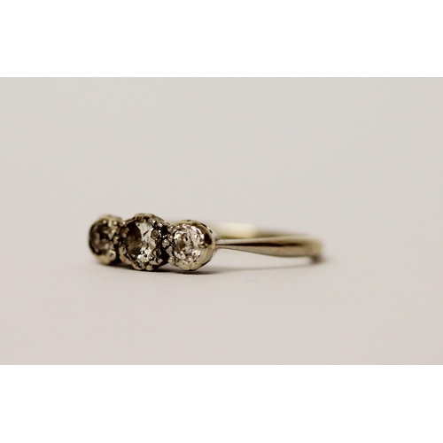 523 - A three stone diamond ring, on 18ct white gold band, ring size I/J, weight 2.4g