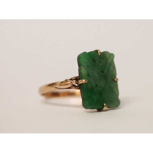 525 - A carved jade panel ring, on 14ct rose gold band. Ring size Q, gross weight 3.8g, - shank has been c... 