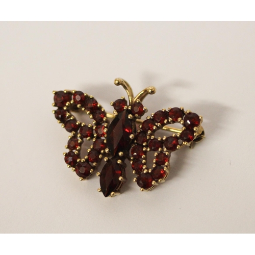 528 - A vintage style garnet set butterfly brooch, in yellow 9ct gold, marked 375, gross weight 3.8g, diam... 