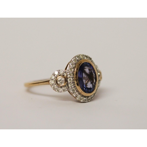 535 - A tanzanite and diamond three panel dress ring, with a large central oval rub over set tanzanite fla... 