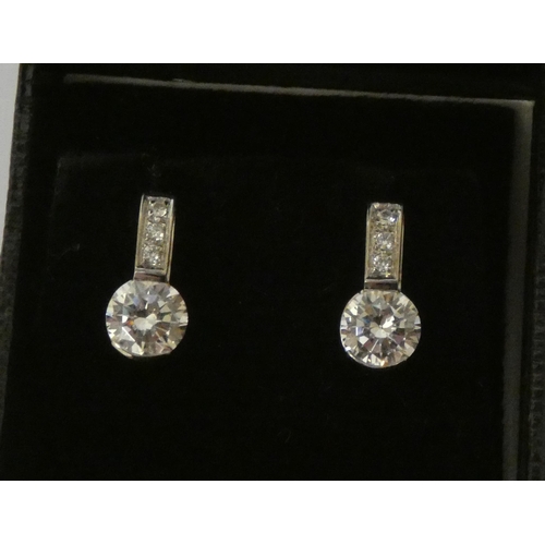 540 - A pair of 18ct gold diamond simulant two stone ear studs, on hallmarked 18ct white gold posts.