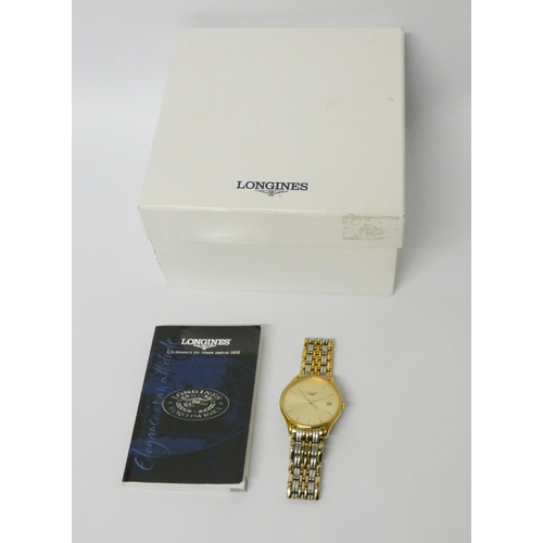 567 - Longines - bicolour gents quartz wristwatch with champagne dial, booklet and cardboard outer box.