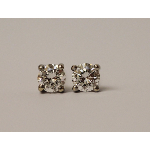 503 - A pair of diamond ear studs, on 18ct safety screw posts