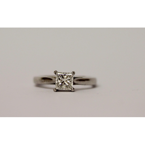 507 - A princess cut diamond solitaire ring, the claw set diamond estimated to weigh 0.75 carats, on hallm... 