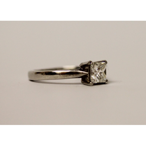 507 - A princess cut diamond solitaire ring, the claw set diamond estimated to weigh 0.75 carats, on hallm... 