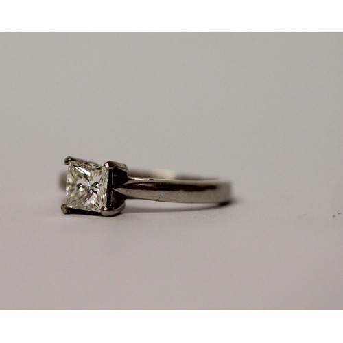 507 - A princess cut diamond solitaire ring, the claw set diamond estimated to weigh 0.75 carats, on hallm... 