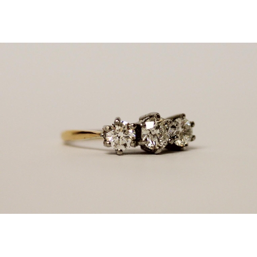 508 - A three stone diamond ring in platinum claw setting, the total diamond weight estimated to be 1.2 ca... 