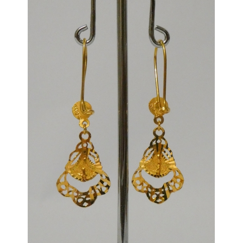 499 - A pair of Eastern high carat yellow gold drop earrings, bearing foreign hallmarks. 3.3 grams