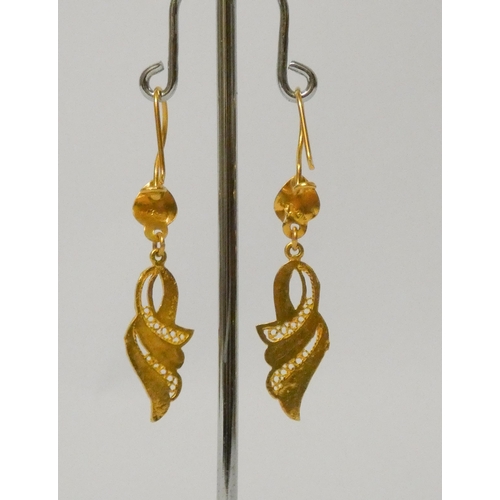 500 - A pair of Eastern high carat yellow gold drop earrings, bearing foreign hallmarks. 3.3 grams