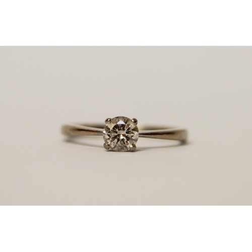 512 - A solitaire diamond ring, claw set with a brilliant cut circular diamond weighing 0.5 carats, on 18c... 