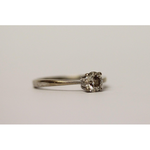 512 - A solitaire diamond ring, claw set with a brilliant cut circular diamond weighing 0.5 carats, on 18c... 