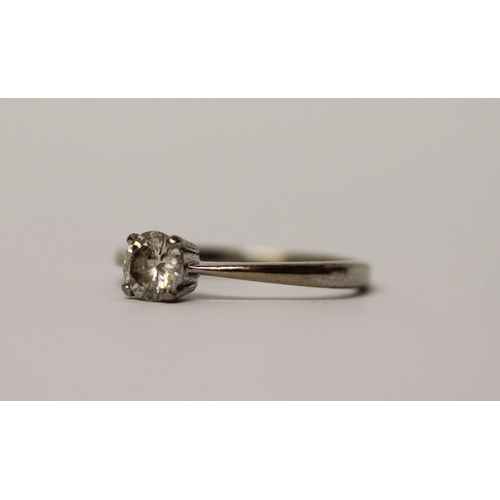 512 - A solitaire diamond ring, claw set with a brilliant cut circular diamond weighing 0.5 carats, on 18c... 