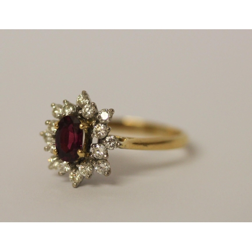 544 - A ruby and diamond oval cluster ring, on 18ct yellow gold band, ring size P, gross weight 3.9g