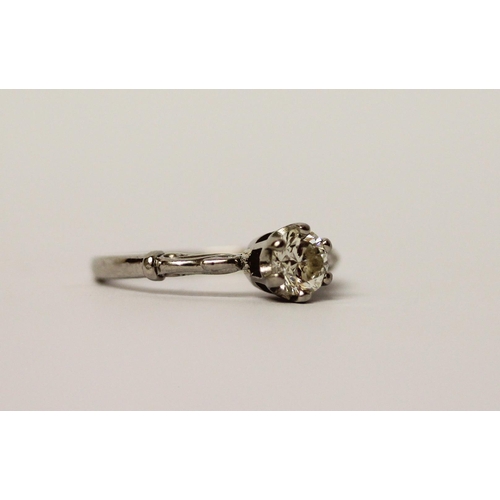 553 - A solitaire diamond ring, the brilliant cut diamond claw set to shaped shoulders in platinum setting... 