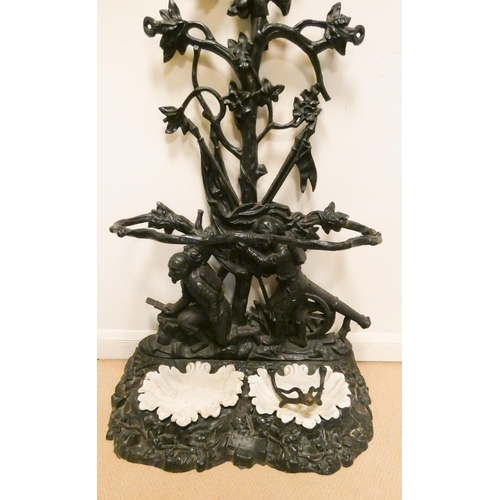 383 - A Victorian black painted cast iron tree style hall stand, with soldier figures and cannon cast on t... 