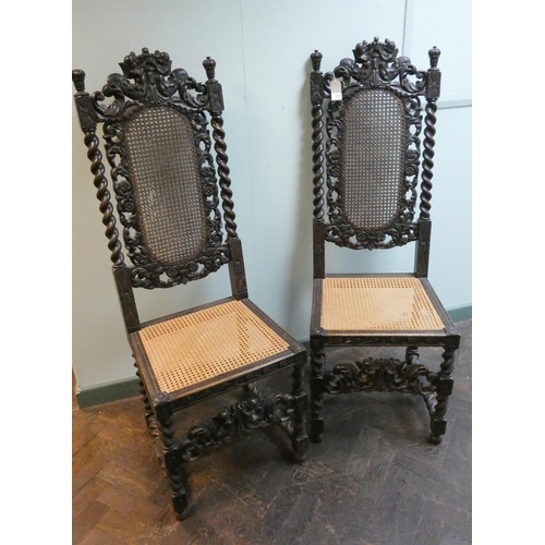 389 - A pair of Jacobean style carved oak barley twist  high backed  hall chairs with cane panelled seats ... 