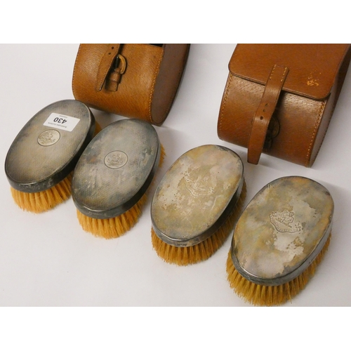 430 - Two pairs of vintage gents hairbrushes with engraved armorial, within leather cases