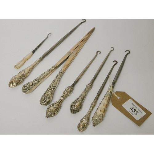 433 - A collection of silver handled button hooks and a pair of glove stretchers