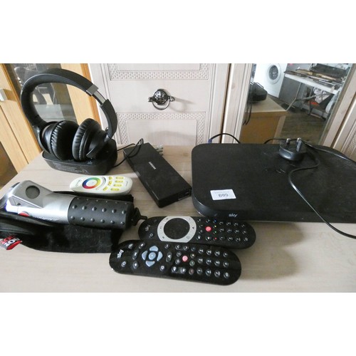 699 - A Sky box, pair of cordless rechargeable headphones, chain checker for push bike, remotes etc...