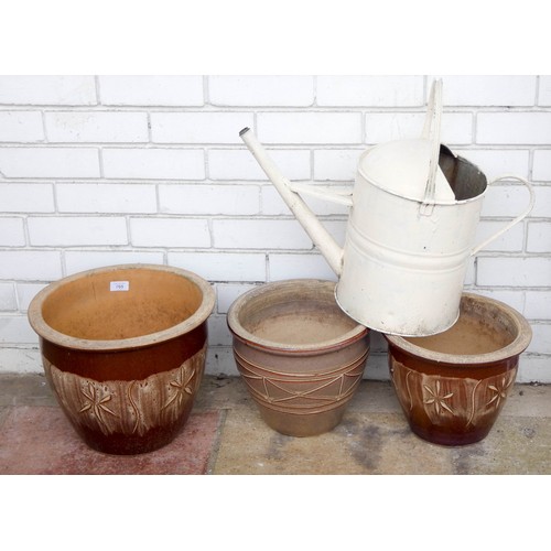 705 - Three circular garden pots together with a galvanised watering can...