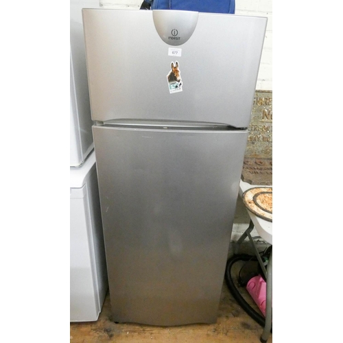 301 - An Indesit fridge freezer in silver case with large fridge compartment on the bottom and small freez... 