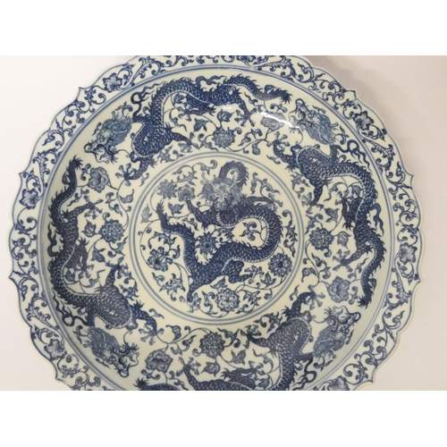 266 - A Chinese blue and white dish decorated with dragons chasing pearls, character mark to base, diamete... 